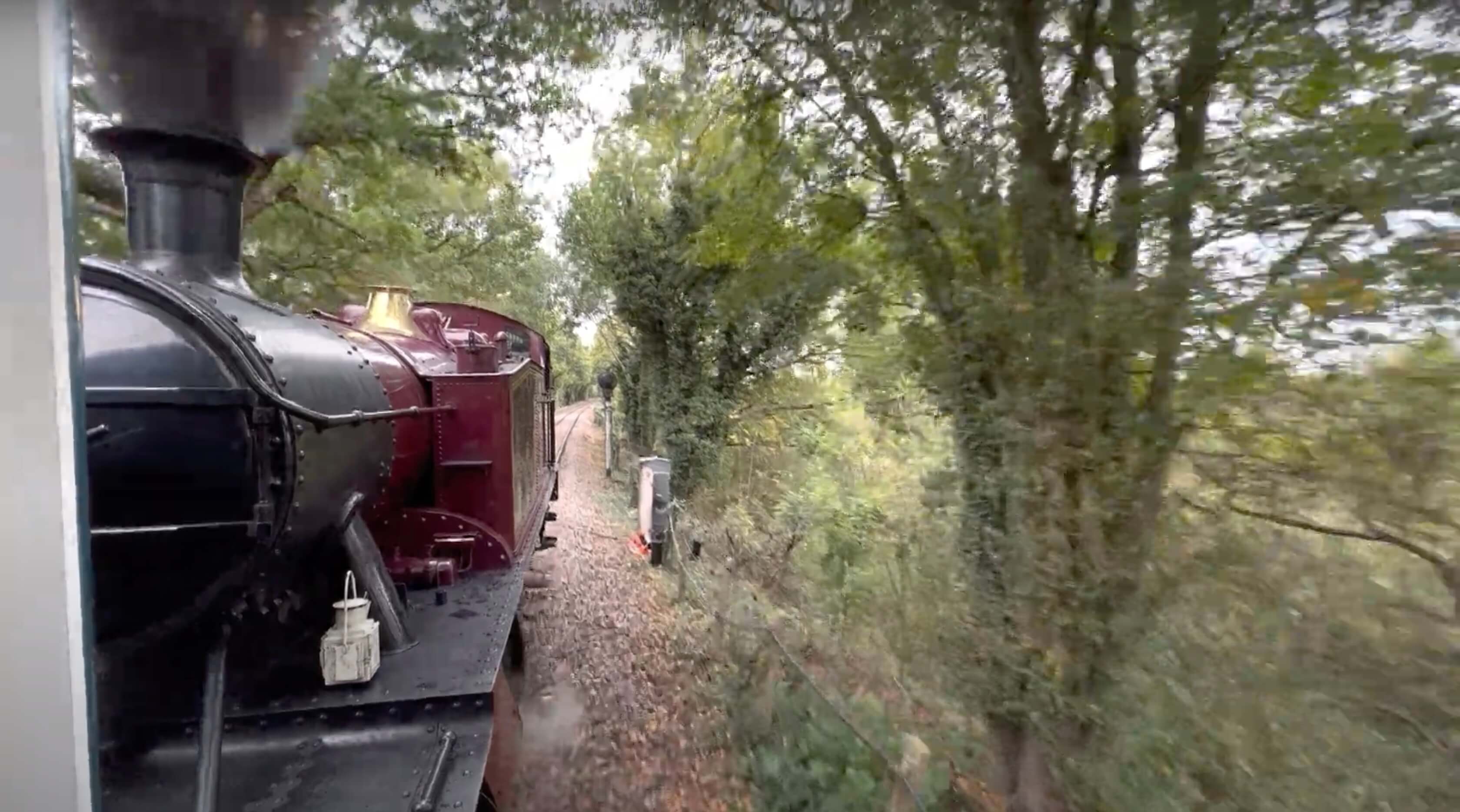 View from a moving steam train, looking closely at the boiler